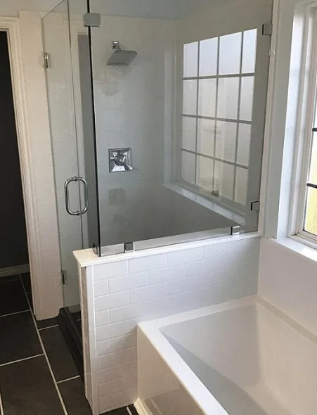 A glass shower enclosure next to a soaking tub