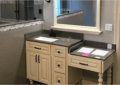 A bathroom sink and mirror after a remodel