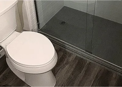 A newly installed toilet in a finished bathroom